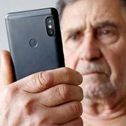 Elderly man looking at his smartphone